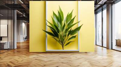 Green Leaves and White Frame on Yellow Background. Wall mural