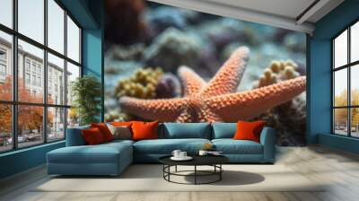 Starfish resting on coral reef in blue water. Wall mural