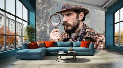 A male detective or spy wearing a hat and a magnifying glass in his hand. Investigating and searching for evidence. Finding a way out of a difficult situation. Illustration for cover, brochure, etc. Wall mural