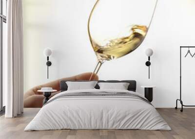 glass of white wine holding by a hand Wall mural