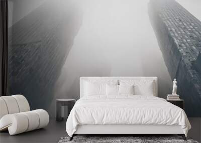 City skyline disappears into thick fog, creating a dreamy and surreal scene. Wall mural