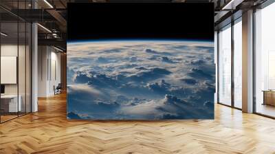 A breathtaking view of Earth from space, showing a vast expanse of fluffy clouds illuminated by the sun's rays. Wall mural