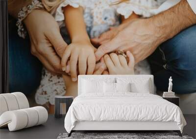 A family of three hold hands, showing love and connection. Wall mural