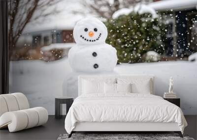 A snowman with a carrot nose and black eyes stands in a snowy yard with falling snow in the background. Wall mural