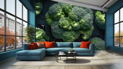 Fresh green broccoli with water drops on black background. Top view. Wall mural