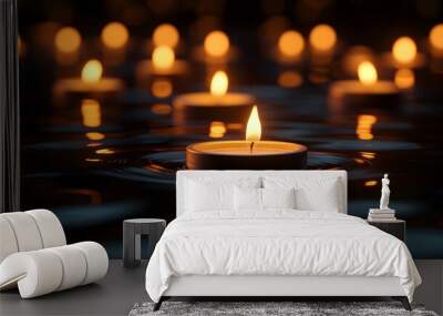 Lit candles creating a warm and tranquil atmosphere in a dimly lit room Wall mural