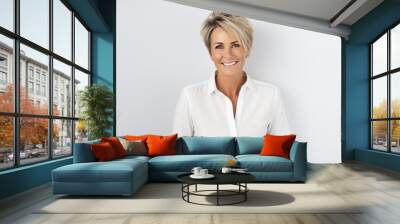 Portrait of a beautiful business woman smiling at the camera while standing against grey background Wall mural