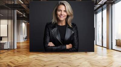 Portrait of a beautiful woman in a leather jacket on a dark background Wall mural