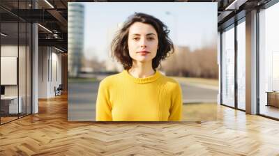 Portrait of a beautiful young brunette woman in a yellow sweater Wall mural