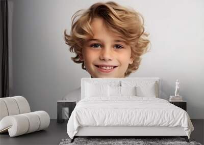 Portrait of a cute little boy with blond curly hair, studio shot Wall mural