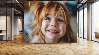 Portrait of a cute little girl with red hair smiling at the camera Wall mural