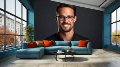 Portrait of a handsome young man wearing glasses over dark background. Wall mural