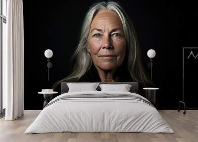 Portrait of an elderly woman on a black background. Studio shot. Wall mural