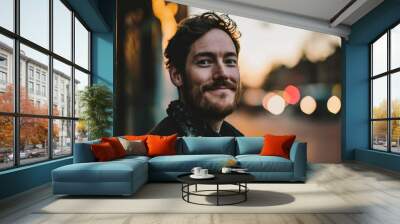 Portrait of handsome young man with beard in the city at night Wall mural