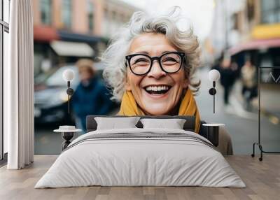 Portrait of happy senior woman with eyeglasses in the city Wall mural