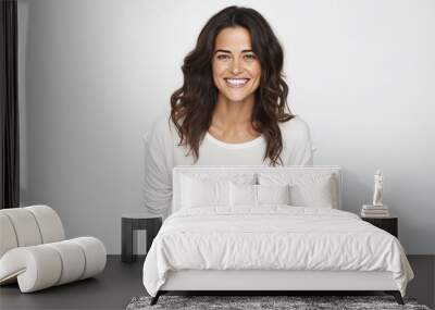 Portrait of happy young woman smiling at camera over white background. Wall mural