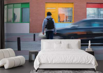 Caucasian boy about to be hit by a car in a crosswalk on his way to school. Road safety education. Wall mural