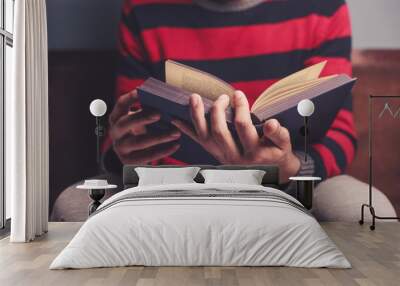 Man is reading a big book Wall mural