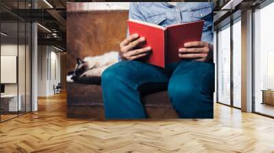 man reading on sofa with cat Wall mural