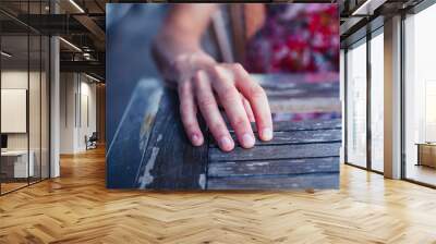 Woman resting hand on table Wall mural