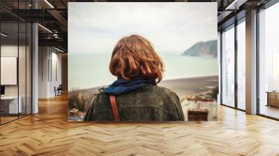 Young woman admiring the seaside view Wall mural