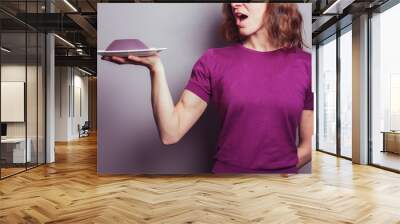 Young woman in purple serving jelly Wall mural