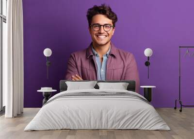 Young buisnessman wearing eyeglasses standing against purple background Wall mural