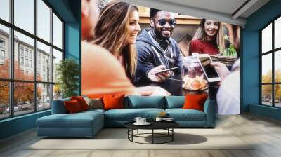 A group of young people get together for breakfast having fun using smartphones and social networks - lifestyle concept of friends meeting and using internet and new technologies Wall mural