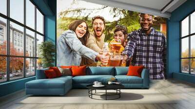 Cheers - multiracial group of happy people toasting joining beer mugs and laughing looking at the camera standing together outdoors in the countryside - people and alcohol lifestyle concept Wall mural