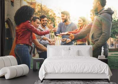 Group of multiracial people playing at Rock Paper Scissors game. Students from different culture having fun outdoors Wall mural