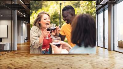 Happy multiracial friends celebrating at picnic toasting with red wine - people lifestyle concept Wall mural