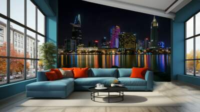 The best of night view in Ho Chi Minh City, Vietnam. Colorful of city light beside the Saigon river with skyline at sunset. Royalty high quality free stock image. Wall mural