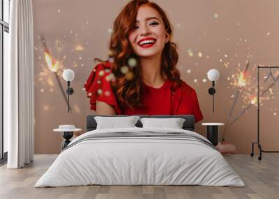 Adorable white woman posing with bengal lights. Gorgeous red-haired girl holding sparklers and laughing in new year. Wall mural