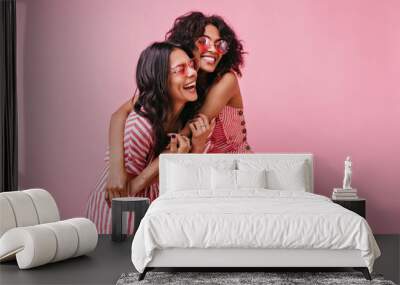 Amazing, beautiful lady rejoice and enjoy photo shoot in pink. African girls with curly hair in sunglasses laugh Wall mural