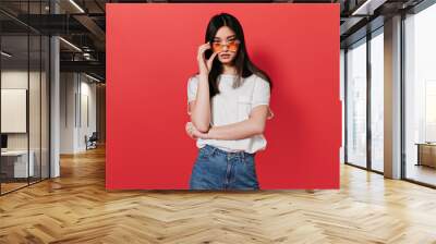 Asian girl in white T-shirt takes off her sunglasses Wall mural