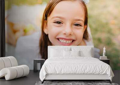 Close-up portrait of dark-eyed girl with cheerful smile posing with pleasure outdoor. Pretty little lady with brown eyes and long eyelashes laughing on blur nature background. Wall mural