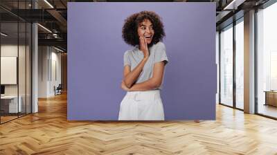 Joyful girl in gray outfit laughs on purple background. Attractive woman in white skirt smiling and posing on isolated backdrop Wall mural