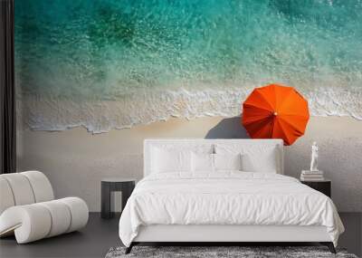 Overhead Aerial View of Vibrant Orange Umbrella on Tranquil Summer Beach with Turquoise Ocean Wall mural