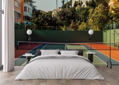 Vibrant Tennis Court in Scenic Urban Landscape with Lush Greenery Wall mural