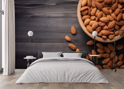 Almonds in wooden bowl on dark wood table. Almond concept with copyspace.topview. Wall mural