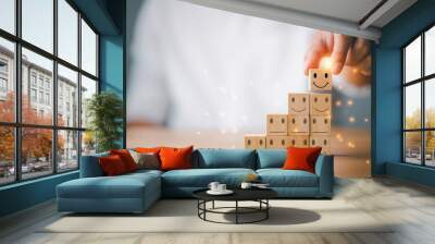 Customer service and Satisfaction concept ,Business people show a feedback with smile face wood cube happy Smiley face icon to give satisfaction in service. rating very impressed. Wall mural