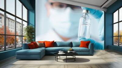 Development and creation of coronavirus vaccine COVID-19 .Coronavirus Vaccine concept in hand of doctor blue vaccine jar. Vaccine Concept of fight against coronavirus. Wall mural