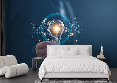 Hand of businessman holding illuminated light bulb with network connection line, idea, innovation and inspiration concept. concept creativity with bulbs that shine glitter. Wall mural