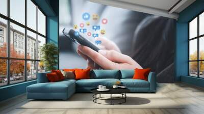 Social media and digital online concept, woman using smart phone on sofa in the morning at home. The concept of living on vacation and playing social media at home. Wall mural