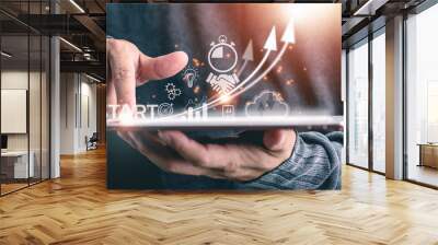 Startup concept with icon business and network connection on modern virtual interface from digital tablet.man touching on tablet. Wall mural