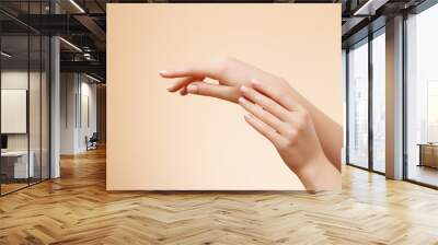 Closeup image of beautiful woman's hands with light pink manicure on the nails. Skin care for hands, manicure and beauty treatment. Elegant and graceful hands with slender graceful fingers Wall mural