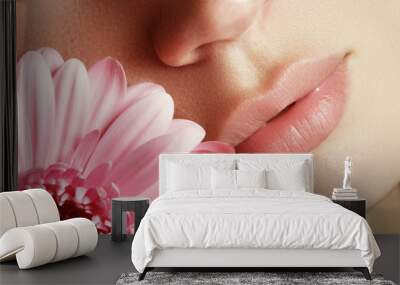 Lips with flower. Close-up beautiful female lips with bright lips Wall mural