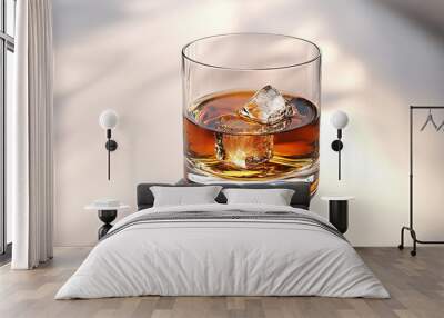 Simple glass of whiskey with ice cube on sunlit surface. Wall mural