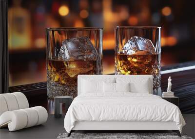 Two crystal glasses of whiskey with ice on wooden bar Wall mural