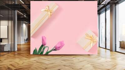 Beautiful pink tulips with gold gift box on  pink paper background. Wall mural